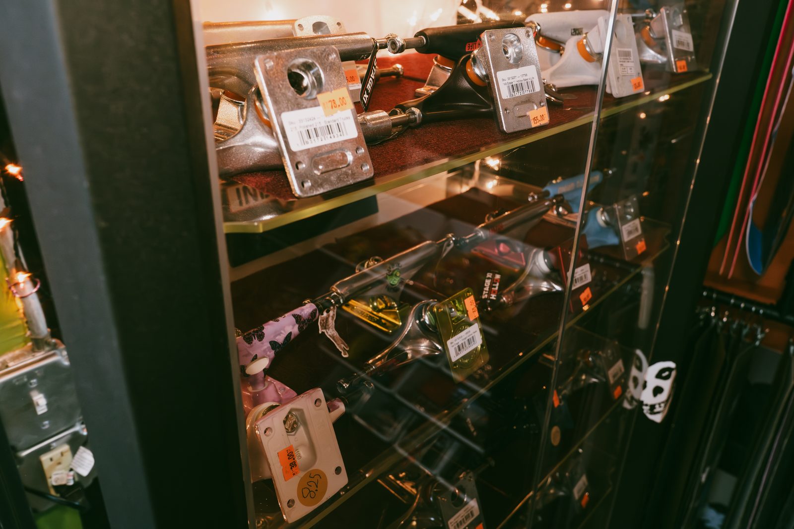 Skateboard trucks in the glass display cabinet at Broke Sk8
